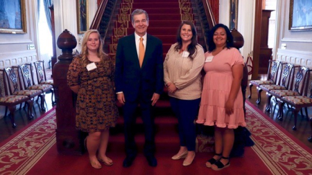 Maddy, Whitney, Angela with Governor Cooper